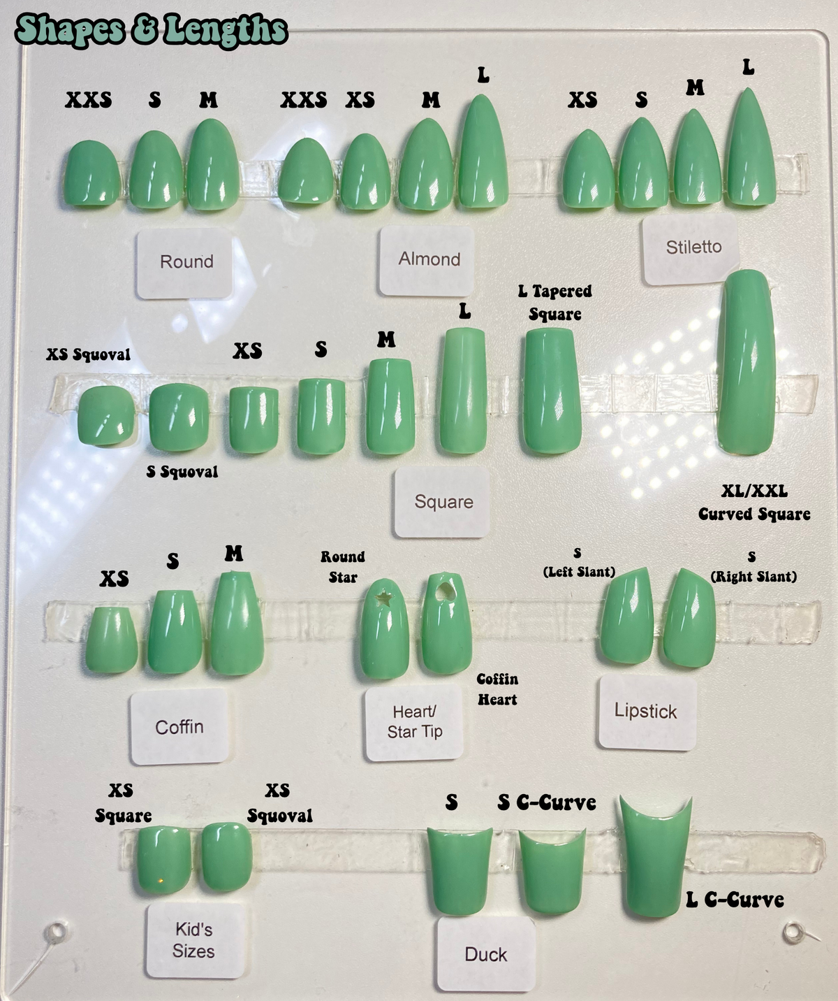 A nail tip size and shape chart displaying multiple green artificial nail samples labeled by shape and size, such as almond, stiletto, square, coffin, heart/star tip, lipstick, duck, and c-curve, on a white background.